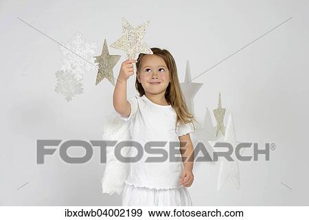 "Child, girl wearing an angel costume with stars, Christmas, festive season" View Large Photo Image Stock Photo - "Child, girl wearing an angel costume with stars, Christmas, festive season". Fotosearch