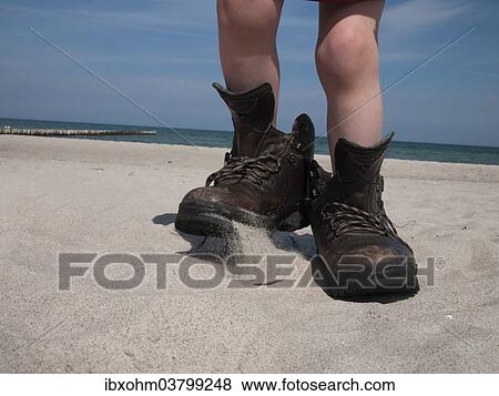 "Child wearing large hiking boots on a sandy beach, Mecklenburg-Western Pomerania, Germany, Europe" View Large Photo Image Stock Photo - "Child wearing large hiking boots on a sandy beach, Mecklenburg-Western Pomerania, Germany, Europe". Fotosearch