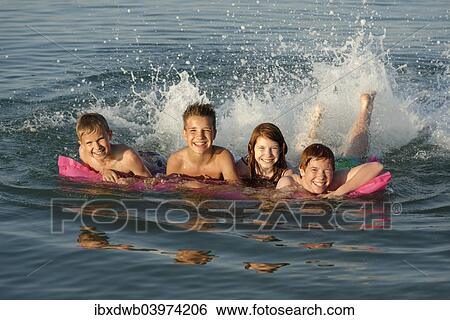 "Children on a lilo in the sea, Mediterranean near Fano, Marche, Adriatic, Italy, Europe" View Large Photo Image Stock Photograph - "Children on a lilo in the sea, Mediterranean near Fano, Marche, Adriatic, Italy, Europe". Fotosearch