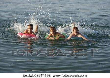 "Children on floating tyres in the sea, Mediterranean near Fano, Marche, Adriatic, Italy, Europe" View Large Photo Image Stock Photo - "Children on floating tyres in the sea, Mediterranean near Fano, Marche, Adriatic, Italy, Europe". Fotosearch