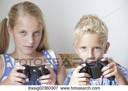 Stock Photo - "Children playing video games, game console". Fotosearch