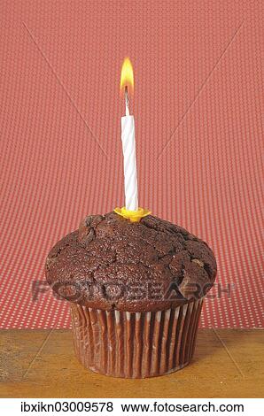Chocolate muffin with a birthday candle View Large Photo Image Stock Photo - Chocolate muffin with a birthday candle. Fotosearch