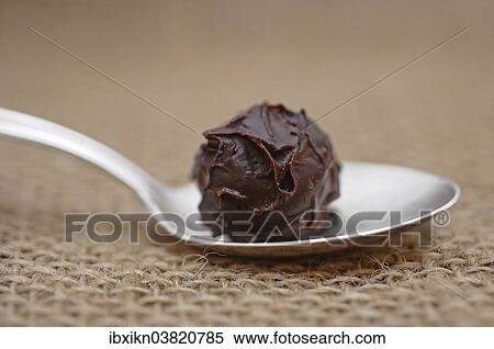 Chocolate truffle on a silver spoon View Large Photo Image Stock Photography - Chocolate truffle on a silver spoon. Fotosearch