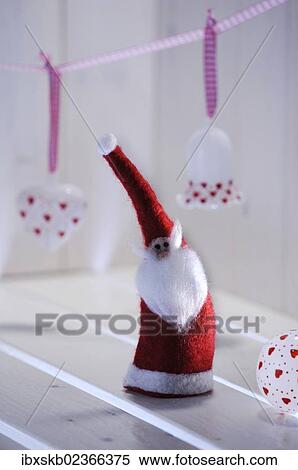 Christmas ambience with a felt Santa Claus and Christmas tree ornaments made of glass View Large Photo Image Stock Photography - Christmas ambience with a felt Santa Claus and Christmas tree ornaments made of glass. Fotosearch