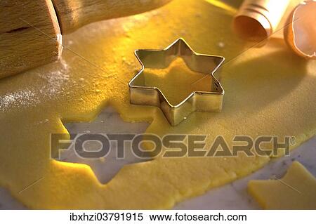 Christmas cookies being cut out in a star shape from rolled out dough View Large Photo Image Stock Photography - Christmas cookies being cut out in a star shape from rolled out dough. Fotosearch