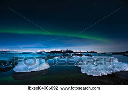 "Chunks of ice in the water at the blue hour with polar lights, Jokulsarlon lake, Vik, Iceland, Europe" View Large Photo Image Stock Image - "Chunks of ice in the water at the blue hour with polar lights, Jokulsarlon lake, Vik, Iceland, Europe". Fotosearch