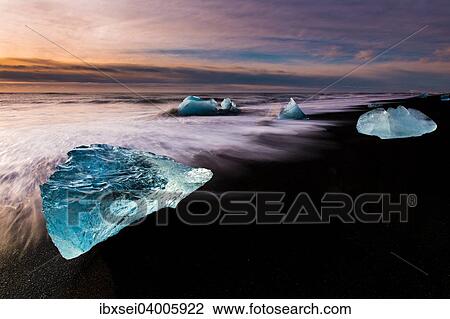 "Chunks of ice on black lava sand beach at sunrise, lake Jokulsarlon, Vik, Iceland, Europe" View Large Photo Image Stock Image - "Chunks of ice on black lava sand beach at sunrise, lake Jokulsarlon, Vik, Iceland, Europe". Fotosearch