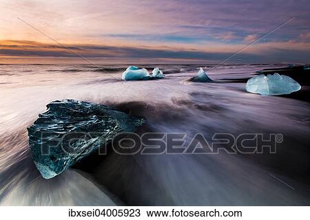 "Chunks of ice on black lava sand beach at sunrise, Jokularsalon, Vik, Iceland, Europe" View Large Photo Image Stock Image - "Chunks of ice on black lava sand beach at sunrise, Jokularsalon, Vik, Iceland, Europe". Fotosearch