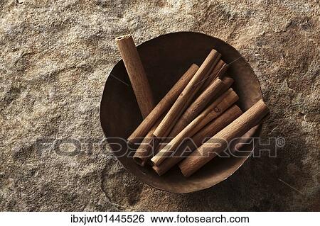 Cinnamon sticks (Cinnamomum) in a copper bowl on a stone surface View Large Photo Image Stock Photograph - Cinnamon sticks (Cinnamomum) in a copper bowl on a stone surface. Fotosearch