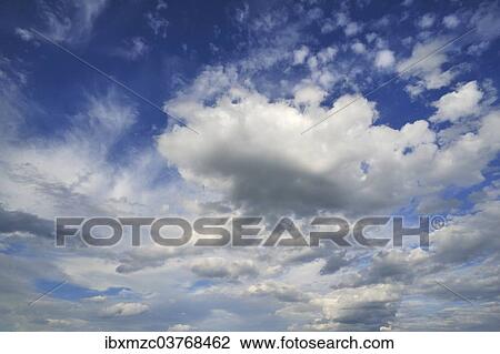Stock Image - Cirrus clouds and cumulus clouds. Fotosearch