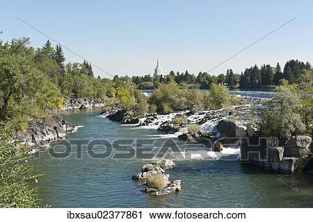 Stock Image - "City beside a river, waterfall, Snake River, Idaho Falls, Idaho, Western United States, United States of America, North America". Fotosearch