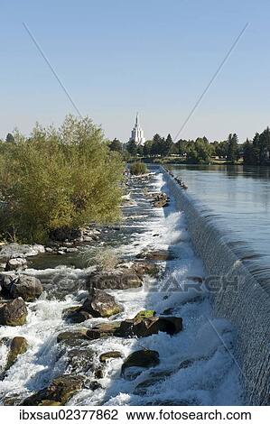 Stock Image - "City beside a river, waterfall, Snake River, Idaho Falls, Idaho, Western United States, United States of America, North America". Fotosearch