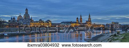 Stock Image - "Cityscape of Dresden during the blue hour, UNESCO World Heritage Site, Elbe river, historic centre, Dresden, Saxony, Germany, Europe". Fotosearch