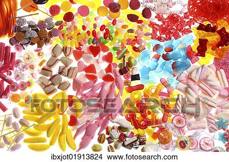 Picture - "Clear plastic bags with a variety of fruit gums, marshmallows, candies, lollipops, cookies and gummy bears". Fotosearch