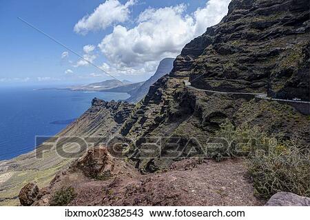 Stock Image - "Cliffs and a road near Artenara, Gran Canaria, Canary Islands, Spain, Europe, PublicGround, Europe". Fotosearch