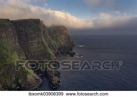 "Cliffs and sea in evening light, near Lopra, Suouroy, Faroe Islands, Denmark, Europe" View Large Photo Image Stock Photo - "Cliffs and sea in evening light, near Lopra, Suouroy, Faroe Islands, Denmark, Europe". Fotosearch