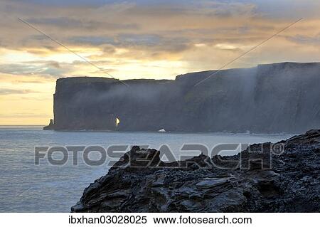 Stock Photography - "Cliffs in the evening light, Dyrholaey, Vik i Myrdal, Southern Region, Iceland, Europe". Fotosearch