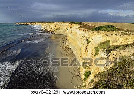 "Cliffs in the evening light with rain clouds, Mari Ermi, Sinis Peninsula, Province of Oristano, Sardinia, Italy, Europe" View Large Photo Image Stock Image - "Cliffs in the evening light with rain clouds, Mari Ermi, Sinis Peninsula, Province of Oristano, Sardinia, Italy, Europe". Fotosearch