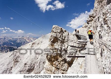 "Climber climbing along the Via Ferrata Ivano Dibona climbing route on Monte Cristallo to the summit of Cristallino, Dolomites, Belluno, Italy, Europe" View Large Photo Image Stock Photo - "Climber climbing along the Via Ferrata Ivano Dibona climbing route on Monte Cristallo to the summit of Cristallino, Dolomites, Belluno, Italy, Europe". Fotosearch