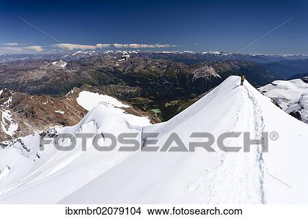 Picture - "Climber descending Mt Piz Palu, on the summit ridge, Grisons, Switzerland, Europe". Fotosearch