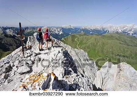"Climber on the summit of Colac on the Via Ferrata dei Finanzieri in Val di Fassa, Dolomites, behind the Rose Garden Group and the Latemar, Trentino Province, Italy, Europe" View Large Photo Image Stock Image - "Climber on the summit of Colac on the Via Ferrata dei Finanzieri in Val di Fassa, Dolomites, behind the Rose Garden Group and the Latemar, Trentino Province, Italy, Europe". Fotosearch