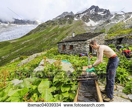 "Climber washing himself at a fountain in the Trient area, Canton of Valais, Switzerland, Europe" View Large Photo Image Picture - "Climber washing himself at a fountain in the Trient area, Canton of Valais, Switzerland, Europe". Fotosearch