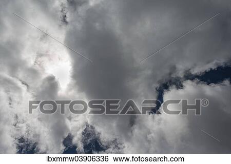 Clouds against a dark sky View Large Photo Image Stock Photograph - Clouds against a dark sky. Fotosearch