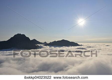 "Clouds and mountain peaks, view from Offersoykammen, Lofoten, Norway, Europe" View Large Photo Image Stock Image - "Clouds and mountain peaks, view from Offersoykammen, Lofoten, Norway, Europe". Fotosearch