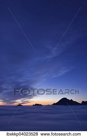 "Clouds and mountain peaks, view from Offersoykammen at dusk, Lofoten, Norway, Europe" View Large Photo Image Stock Photo - "Clouds and mountain peaks, view from Offersoykammen at dusk, Lofoten, Norway, Europe". Fotosearch
