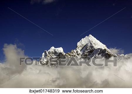 Stock Photo - "Clouds in front of Mt. Kangtega and Mt. Thamserku, Khumbu, Sagarmatha National Park, Nepal, Asia". Fotosearch