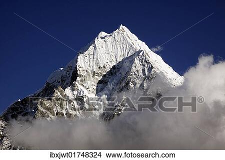 Picture - "Clouds in front of Mt. Thamserku, Khumbu, Sagarmatha National Park, Nepal, Asia". Fotosearch