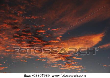 Stock Photo - "Clouds in the sky at dawn, Germany, Europe". Fotosearch
