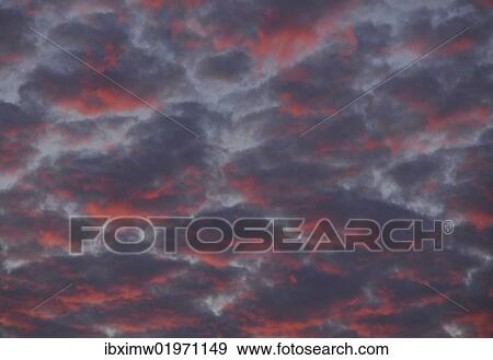 Clouds in the sky at sunset View Large Photo Image Stock Photo - Clouds in the sky at sunset. Fotosearch