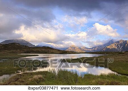 "Cloudy sky at Jaufenpass, Passo di Monte Giovo, mountain lake, evening mood, Sterzing, South Tyrol, Italy, Europe" View Large Photo Image Stock Image - "Cloudy sky at Jaufenpass, Passo di Monte Giovo, mountain lake, evening mood, Sterzing, South Tyrol, Italy, Europe". Fotosearch