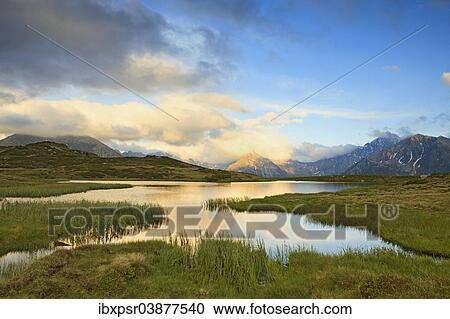 "Cloudy sky at Jaufenpass, Passo di Monte Giovo, mountain lake, evening mood, Sterzing, South Tyrol, Italy, Europe" View Large Photo Image Stock Image - "Cloudy sky at Jaufenpass, Passo di Monte Giovo, mountain lake, evening mood, Sterzing, South Tyrol, Italy, Europe". Fotosearch