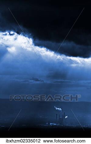 Stock Image - "Cloudy sky, with industrial plant". Fotosearch