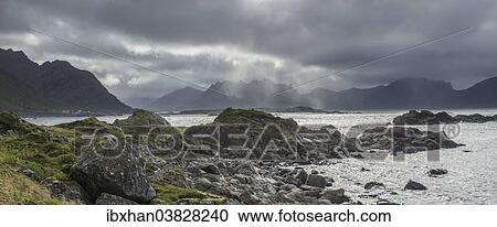 Stock Image - "Coast near Nyksund with rain clouds, Langoya, Vesteralen, Nordland, Norway, Europe". Fotosearch