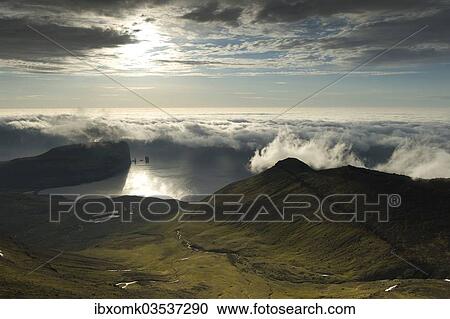 "Coastal landscape with Kollur Mountain and the sea stacks of Risin and Kellingin in the evening light, Eioi, Eysturoy, Faroe Islands, Denmark, Europe" View Large Photo Image Stock Image - "Coastal landscape with Kollur Mountain and the sea stacks of Risin and Kellingin in the evening light, Eioi, Eysturoy, Faroe Islands, Denmark, Europe". Fotosearch