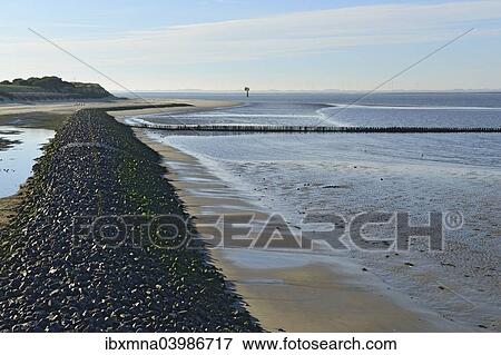 "Coastal protection wall made of stones on the western beach, Spiekeroog, East Frisia, Lower Saxony, Germany, Europe" View Large Photo Image Stock Photo - "Coastal protection wall made of stones on the western beach, Spiekeroog, East Frisia, Lower Saxony, Germany, Europe". Fotosearch