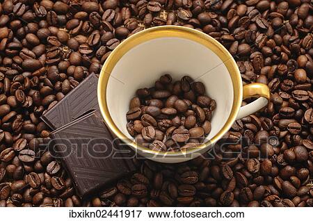 Coffee cup and chocolate on coffee beans View Large Photo Image Stock Photo - Coffee cup and chocolate on coffee beans. Fotosearch