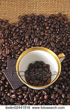 Coffee cup and chocolate on coffee beans View Large Photo Image Stock Photo - Coffee cup and chocolate on coffee beans. Fotosearch