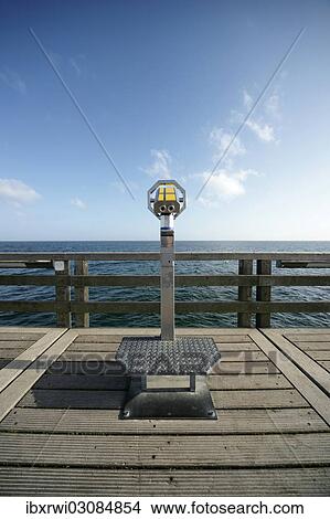"Coin-operated binoculars on a pier in front of the blue sea and blue sky, Boltenhagen, Mecklenburg-Western Pomerania, Germany, Europe" View Large Photo Image Picture - "Coin-operated binoculars on a pier in front of the blue sea and blue sky, Boltenhagen, Mecklenburg-Western Pomerania, Germany, Europe". Fotosearch