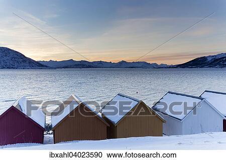 Stock Image - "Colored wooden huts on the Nordfjord, Kvaloya, Troms, Norway, Europe". Fotosearch