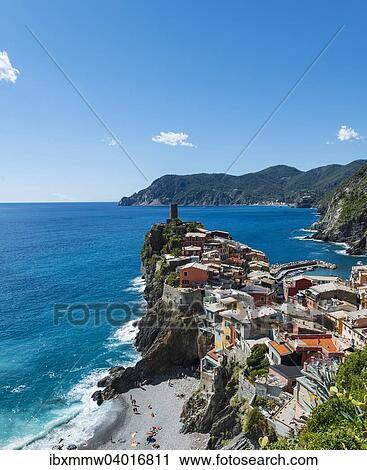 Stock Image - "Colorful houses on cliffs with beach, overlooking Vernazza, La Spezia, Cinque Terre, Liguria, Italy, Europe". Fotosearch