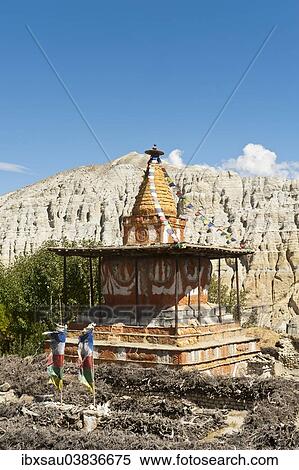 Stock Photography - "Colorful ornate Buddhist stupa, eroded landscape at the back, Charang, Mustang District, Nepal, Asia". Fotosearch