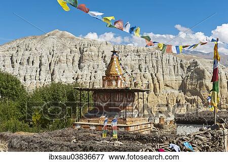 "Colorful ornate Buddhist stupa with colorful prayer flags, eroded landscape at the back, Charang, Mustang District, Nepal, Asia" View Large Photo Image Stock Photo - "Colorful ornate Buddhist stupa with colorful prayer flags, eroded landscape at the back, Charang, Mustang District, Nepal, Asia". Fotosearch