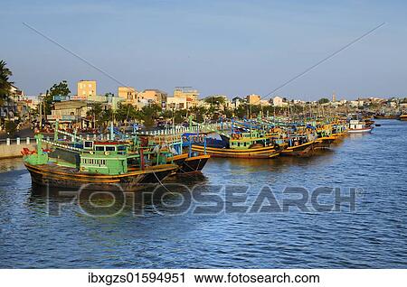 Stock Image - "Colorful wooden fishing boats in the port of Phan Thiet, Vietnam, Asia". Fotosearch