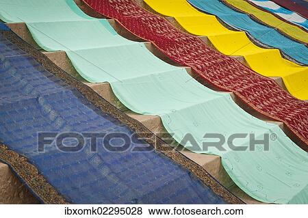 Stock Photo - "Coloured saris laid out to dry on stairs, ghat, Varanasi also known as Banaras, Uttar Pradesh, India, Asia". Fotosearch
