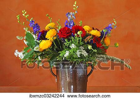 "Colourful bouquet of flowers with ranunculus (Ranunculus asiaticus), roses (Rosa), larkspur (Delphinium) and meadowsweet (Spirea arguta), arranged in a clay pot, Germany, Europe" View Large Photo Image Picture - "Colourful bouquet of flowers with ranunculus (Ranunculus asiaticus), roses (Rosa), larkspur (Delphinium) and meadowsweet (Spirea arguta), arranged in a clay pot, Germany, Europe". Fotosearch
