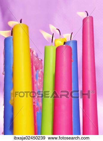 Colourful candles blowing in the wind View Large Photo Image Stock Photo - Colourful candles blowing in the wind. Fotosearch